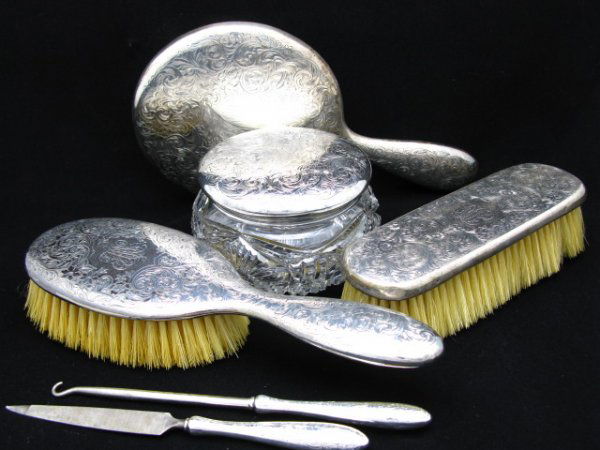 ALLISON WYETH'S 1870 GORHAM SILVER DRESSER SET: A six piece sterling silver dresser set consisting of two brushes 7" x 2 1/4" and 9 1/2" x 3", hand mirror that is 9 1/2"x 5 1/2", a 7 1/8" file and a button hook that measures 7 1/2", plus a very fin
