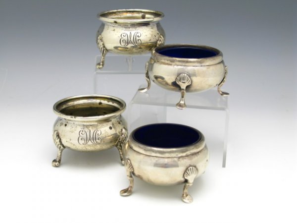 FOUR STERLING SILVER FOOTED SALTS: Two with cobalt liners and two with monogram of EWC for Elizabeth Wyeth Campbell, 3 1/8" across feet and 1 1/2" tall with cobalt liner, 2 3/4" x 1 7/8" tall with the monogram, a total weight of 360 g.