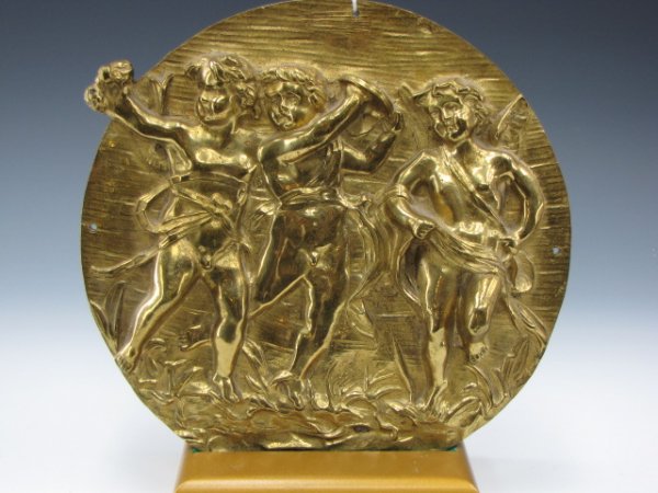A BAS RELIEF BRONZE DORE PLAQUE WITH CUPIDS: Bas relief of three cupids in very high relief, holes to 1, 3, 6, 9 o'clock positions, unsigned, measures approximately 12.75 inches in diameter, gilt finished obverse.