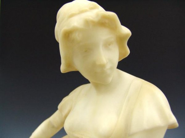 A 19TH CENTURY ITALIAN ALABASTER SCULPTURE: A maiden with flower basket, measures 23 inches tall by approximately 9.5 inches at widest point. Fine carved details to her dress, kerchief and basket.