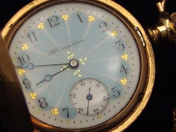 A LADIES HAMPDEN HUNTING CASE ANTIQUE WATCH: 1.25 inch movement, "safety pinion" and "Hampden, Canton, O" marked, "Dueber, Special" marked case, no monogram, beautiful enamel face with inset second hand face at 6 o'clock position, blued hour & m