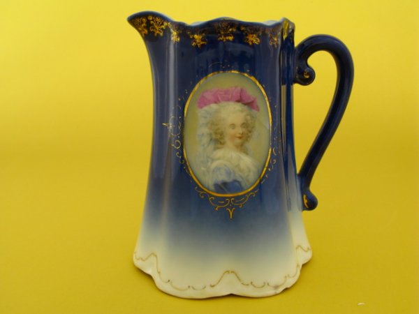A FLOW BLUE PITCHER WITH PORTRAIT: Unmarked, measures 5.5 x 5 inches.