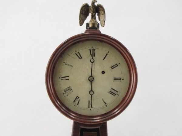 A RARE E. HOWARD & CO. NO. 5 BANJO WALL CLOCK: Circa 1874, 8 day, weight driven time only, measures 29 x 11 x 4 inches, Rosewood veneer case with two reverse painted glass panels and a 7 inch dial in original untouched condition.