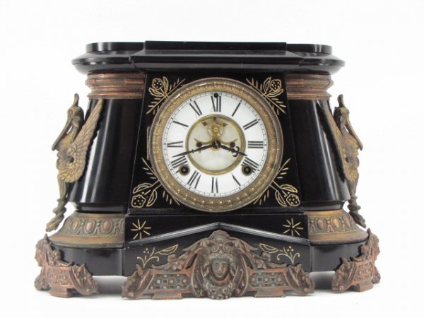 ANSONIA 'POMPEII' IRON CASE MANTLE CLOCK: An 8 day, time and strike model with an excellent double-sunk enamel dial having an open escapement, beveled glass in top door, repainted case and gilt highlights, measures 11 x 14.75 6.25.