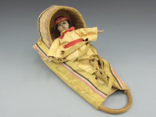 AN APACHE DOLL CRADLE WITH CLOTH DOLL: 20th century, measures 20 inches overall
