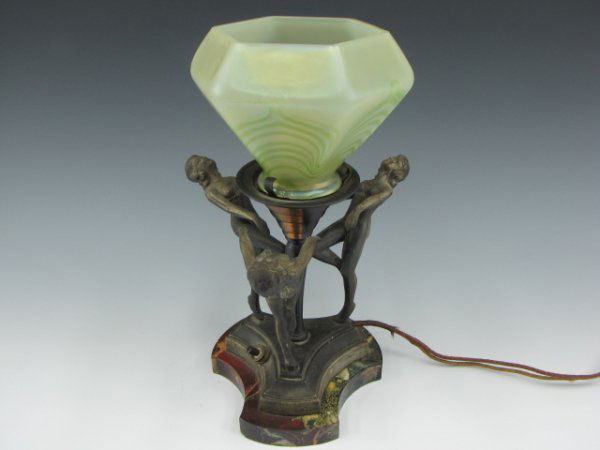 ART DECO THREE WOMEN TABLE LAMP: Polished marble base with cast metal figures of three semi-nude women in artful pose, antique pulled feather form greenish glass shade; stands 11.5 inches to top of shade.