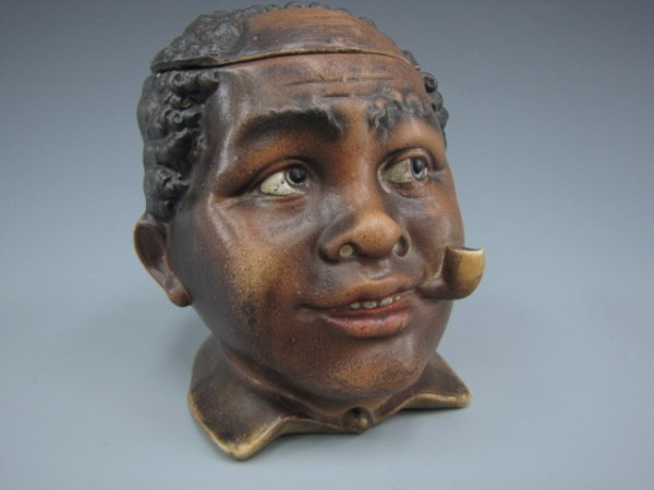 AUSTRIAN FIGURAL BLACK AMERICANA HUMIDOR: Young balding black figure smoking a pipe. Measures 4.5 x 3.75 inches.