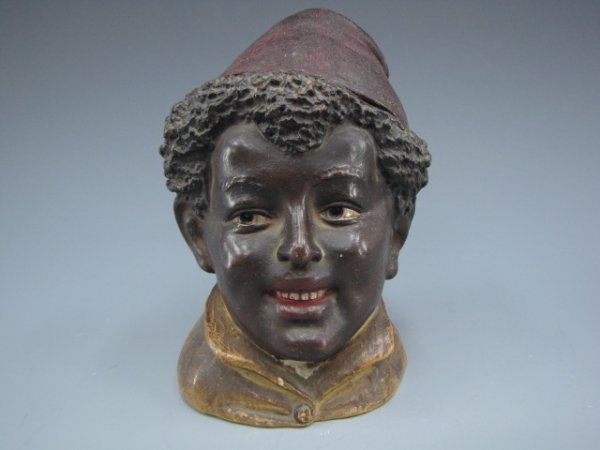 AUSTRIAN FIGURAL HUMIDOR OF BOY IN FEZ: Dark skinned boy with ample hair and tasseled fez, incised "310" to bottom, measures 6 x 4 inches.