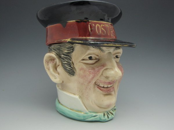 MAJOLICA FIGURAL HUMIDOR OF FRENCH POSTMAN: Friendly face of a French postman with visor cap lid, measures 6.75 x 5.75 inches.
