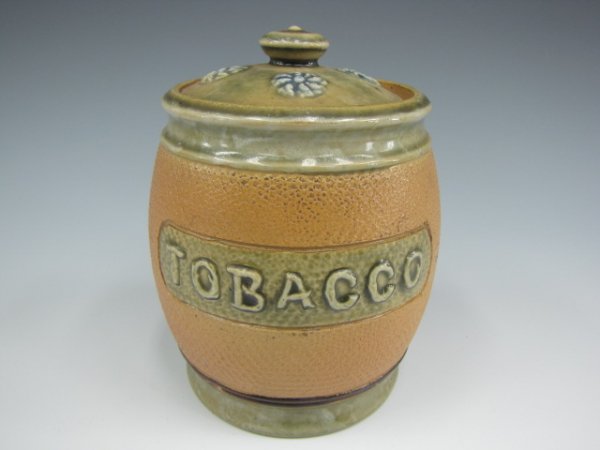 ROYAL DOULTON BARREL FORM HUMIDOR TOBACCO JAR: Nice barrel-form humidor with majolica-like greenish details, embossed "Tobacco" to front, stands 5.5 inches. "Royal Doulton BB6" marked bottom.