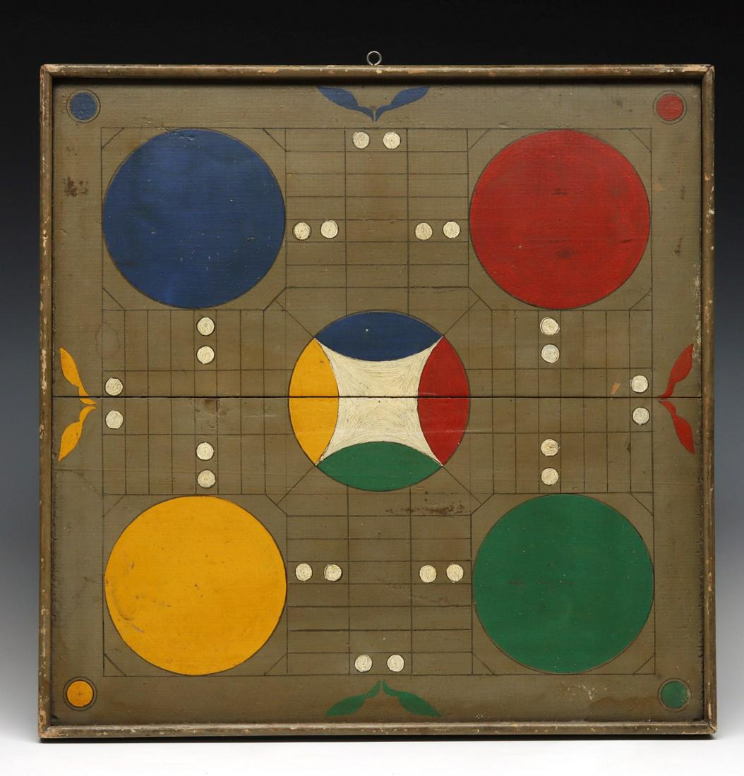 A 19TH C. AMERICAN PAINTED WOOD PARCHEESI GAME BOARD: The two-sided board with applied bull nose molding surrounding the colorful playing fields, one side a parcheesi game board with bright colored roundels and a fiver color central 'Home' area against a