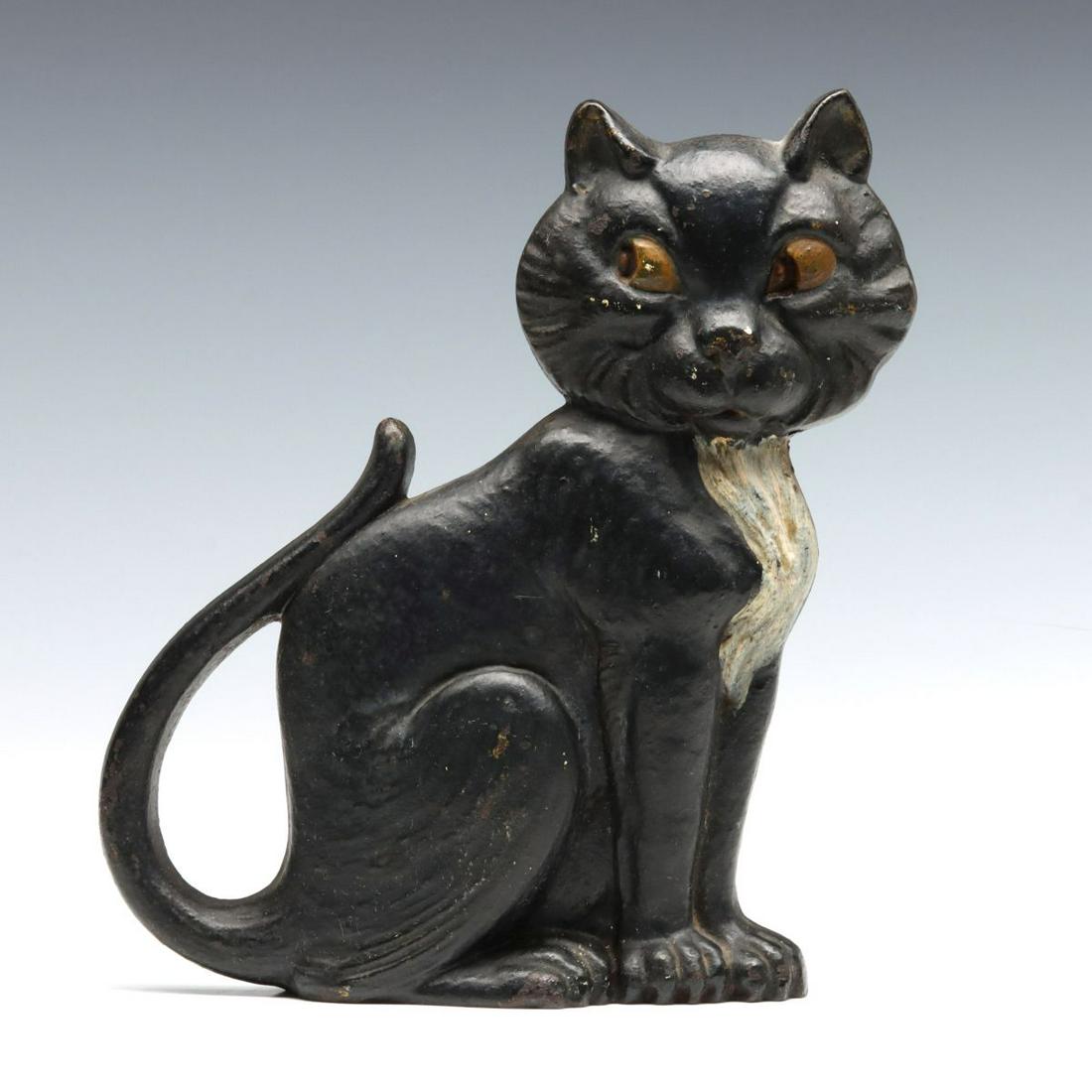 A GREENBLATT STUDIO CAST IRON CAT DOORSTOP, CIRCA 1927: The painted cast iron doorstop, Sitting Cat number 20 by Greenblatt Studio, copyright dated 1927, signed back side. Measures 9 x 7.25 x 2.75 inches. We happily provide seamless in-house packing and sh