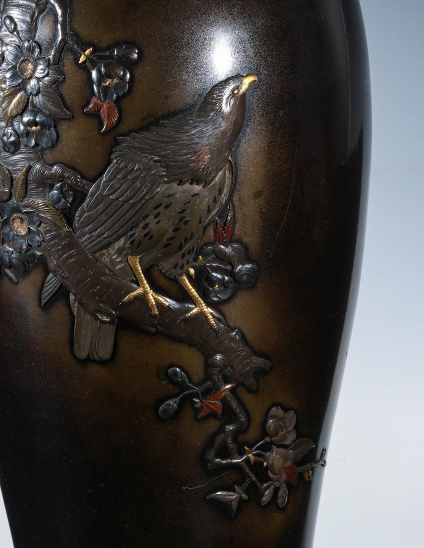 A FINE JAPANESE MEIJI PERIOD MIXED METALS BRONZE VASE: The tall vase with collar over sloping shoulder decorated in applied mixed metals with enamel embellishment and gilt decoration, stamped maker's mark on the base. Measures 13 inches. We happily provid
