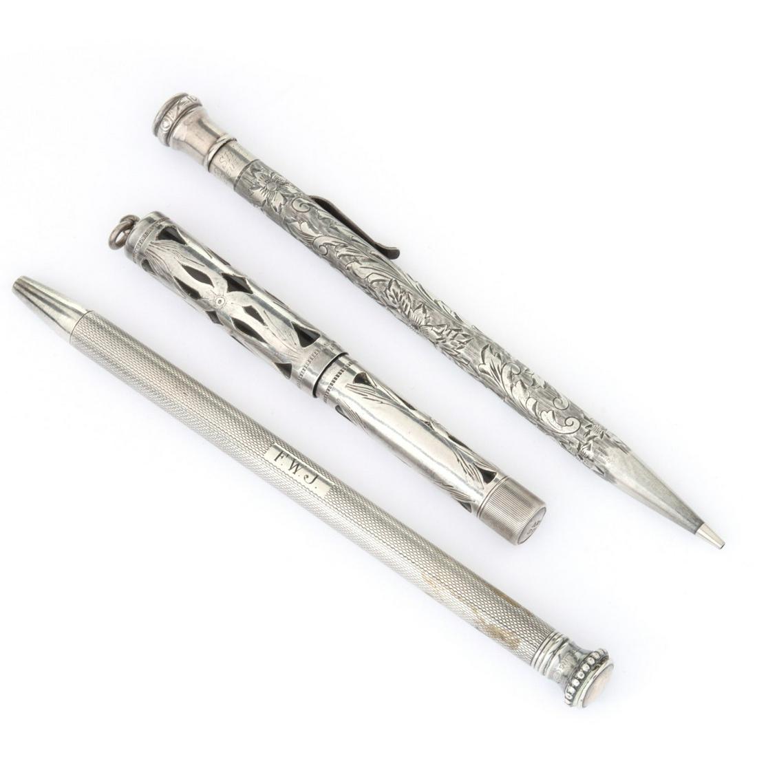THREE STERLING SILVER WRITING INSTRUMENTS: Three examples including a Waterman model 452 fountain pen with sterling silver overlay embellished by hand engraving, an Ever Sharp example with hand engraved decoration overall, plus another with en
