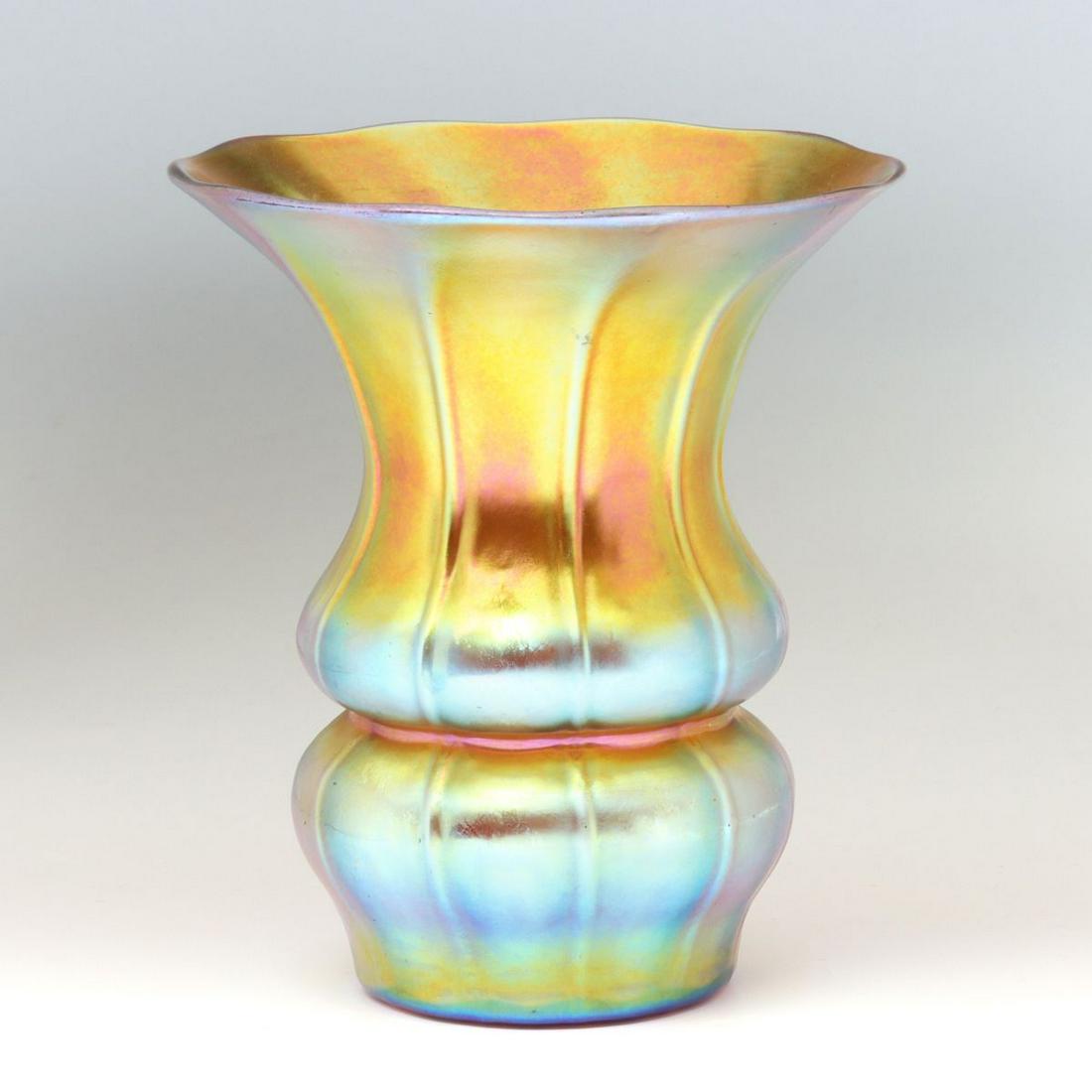 A STEUBEN GOLD AURENE ART GLASS VASE: The trumpet form vase with pronounced ribs and a tightly waisted contraction near the bulbous base, signed by wheel near the pontil on the underside. Measures 6 x 4.25 inches. We happily provide seaml