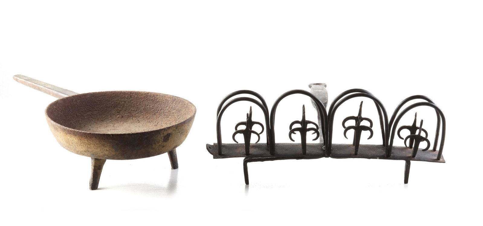 A 19TH CENTURY WROUGHT IRON TOASTER WITH IRON POSSET: The 19th century American wrought iron toaster with ram's horn hangers revolves on an iron stand with long handle. Plus a 19th century cast iron posset pot. Measure 7 x 22 x 15 and 4.25 x 21 x 10 inch
