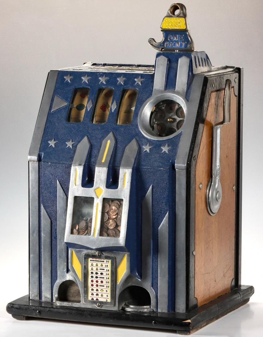 A PACE MFG COMET MODEL 1 CENT SLOT MACHINE C. 1936: The three reel slot machine with Art Deco influence design, pebbled aluminum casting with polished highlights and yellow accents, coin turret above the visible coin carousel over the double jackpot an