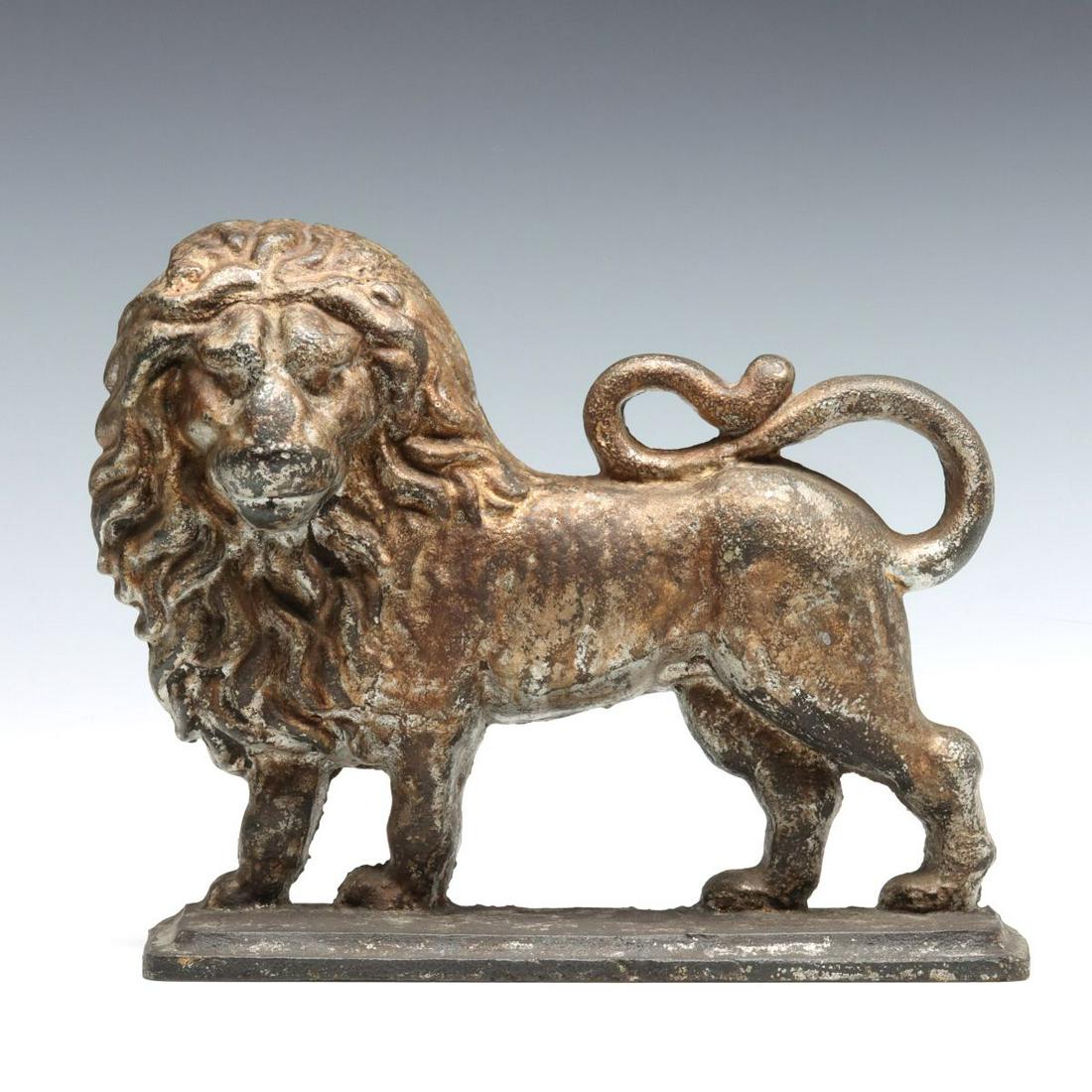 TWO ANTIQUE CAST IRON DOORSTOPS AND RELATED BOOK: The unmarked British Lion doorstop, the Bradley & Hubbard oval medallion with bouquet doorstop and The Doorstop Book by John c. and Nancy M. Smith are offered here as one lot. Doorstops measure 8 x 3.