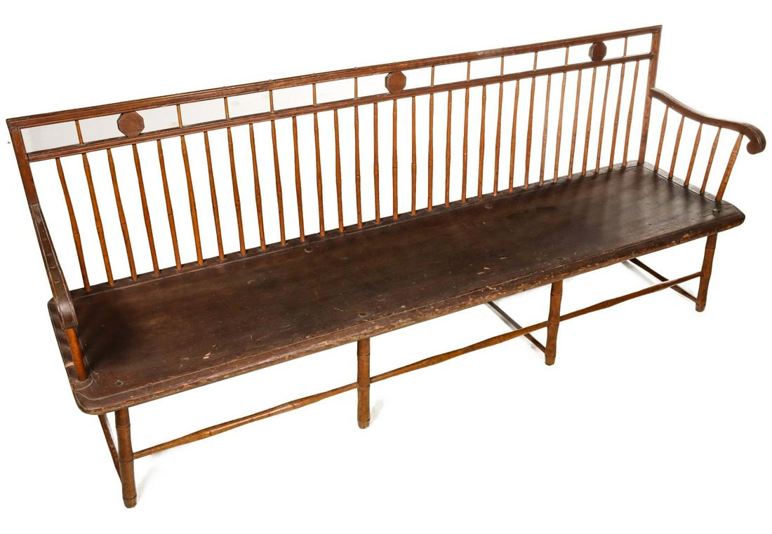 A 19TH C. AMERICAN BIRD CAGE WINDSOR SETTEE: The rod crest rail with spindles and eight sided plaques over spindle back and one-board plank seat, scroll arms supported by spindles and raised on eight legs with faux bamboo turnings. Measures 32.5