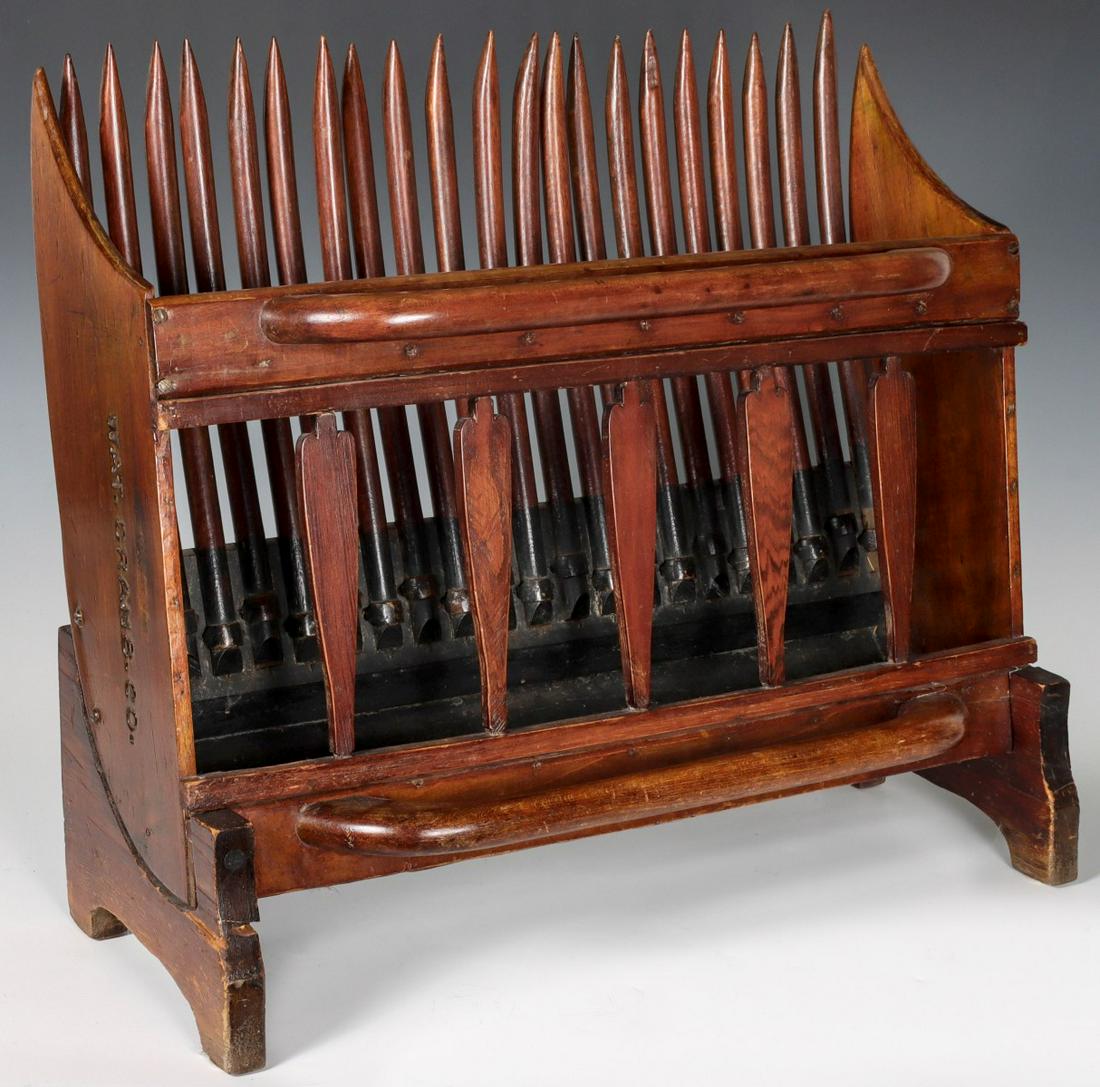 A 19TH C. AMERICAN CRANBERRY PICKER AS MAGAZINE RACK: The American primitive fashioned as a magazine rack with stand added, branded mark of WAT.CRANB.CO. Measures 18 x 21 x 10 inches. We happily provide seamless in-house packing and shipping services on 