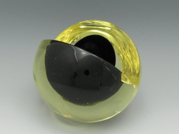 NANNY STILL (Finland 1926-2009) GLASS SCULPTURE: Titled "Lasiveistos" or "Melon" in yellow glass with dark interior, by Finnish designer Nanny Still, . Measures 3-3/4 inches. Signed to bottom, "Nanny Still, Riihimäen Lasi Oy" on polished base.