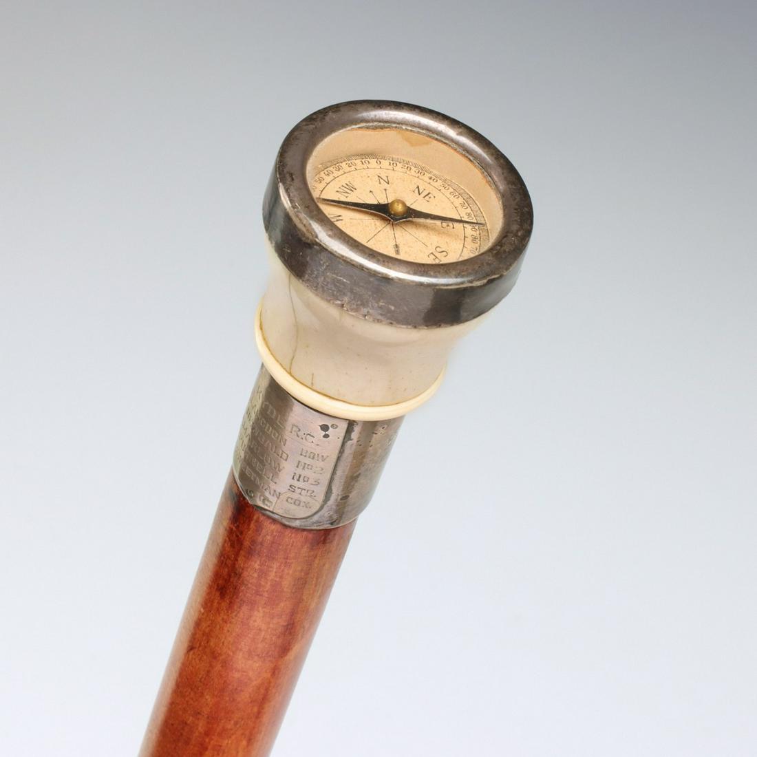 AN 1898 ROWING TEAM PRESENTATION CANE WITH COMPASS: The sterling silver collar with Birmingham hallmarks for 1898 encloses a functioning compass with paper dial within a turned bone collar and hallmarked sterling silver sleeve having applied shield eng