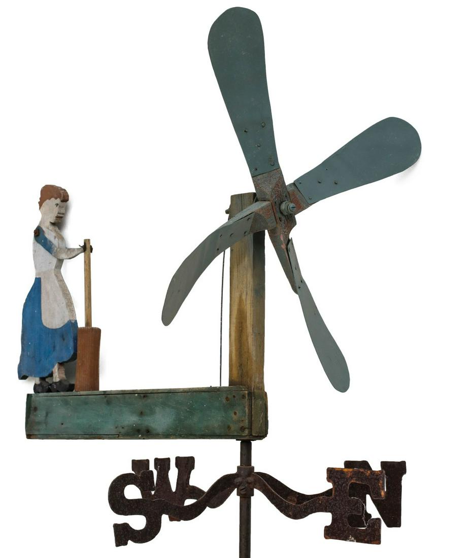 A FOLK ART WHIRLIGIG WITH CHURNING BUTTER PIONEER: The animated wooden whirligig in old paint is mounted ON an iron directional. Measures 23 x 24 inches, 75 inches tall on the pole. We happily provide seamless in-house packing and shipping services on