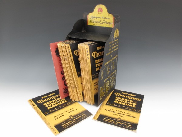 1949 AUTO REPAIR THOMPSON PRODUCTS TECHNICAL LIBRARY SH: A cut and folded sheet metal shelf with printed sides, for Thompson Products Technical Library. Shelf measures 15 x 6.75 x 7.5 inches overall, yellow printed sides with list of publications. This shel