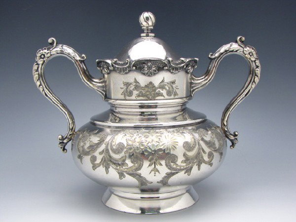 SIX PIECES ENGRAVED VICTORIAN SILVER PLATED TABLEWARE: Includes ornate creamer, sugar and waste bowl, each "Meriden 1995" marked, measure 6.5 x 7.75 x 5.25 inches, 6.5 x 5.5 x 4 inches, and 5.5 x 7 x 4 inches. James Tufts marked mush cup and underplate, c