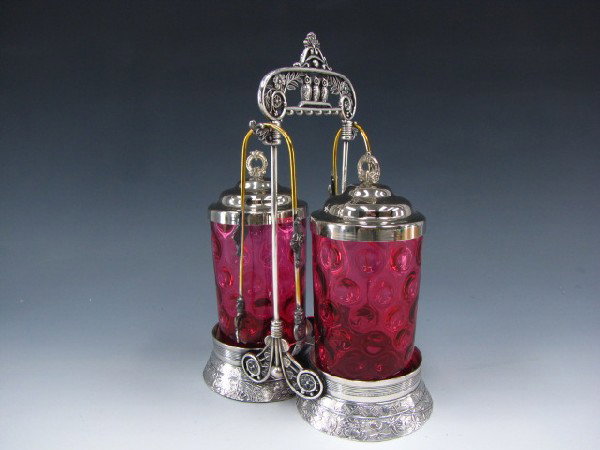 ORNATE VICTORIAN DOUBLE PICKLE CASTOR WITH OWLS: "Derby Quadrupleplate" marked bottom, three perched owls to top, includes clawed tongs, two cranberry spot glass castors, matching lids, measures 11.5 x 5.5 x 8 inches.