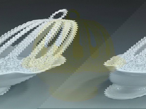 CIRCA 1900 WEDGWOOD CREAMWARE COVERED CITRUS BOWL: Remarkable creamware reticulated covered bowl, with incised 'Wedgwood', both bowl and cover stamped 'Wedgwood, Etruria, England.' Measures 9 x 11.5 inches.