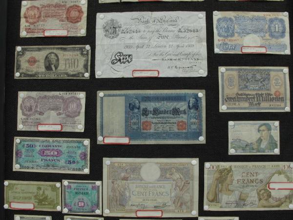28 PIECES OF WWI & WWII ERA EURO & ASIAN CURRENCY: Includes a 1910 dated 100 Reichsmark note, a couple pieces of post-WWI inflation currency and notgeld, including a Cologne 200 Million Mark note, two Bank of England 10 Shilling notes, a 5 pound 1939 