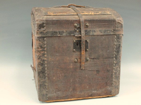 A 19TH CENTURY LADIES (?) HAT BOX TRUNK: Cross-hatched textured domed wood top, metal trim, leather strap and handle to top. Pressed paper and tinted litho to inside lid lining, fitted insert with domed cardboard 'lid' (detached) with painte
