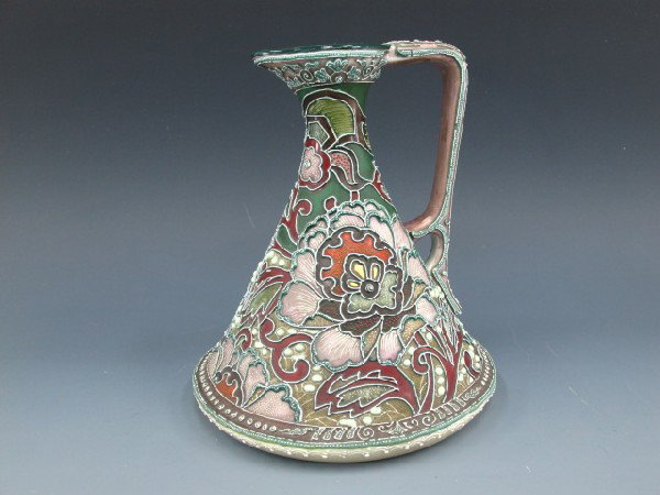 AN UNMARKED NIPPON MORIAGE EWER: Very nice floral themed ewer with raised relief, measures 7 inches high.