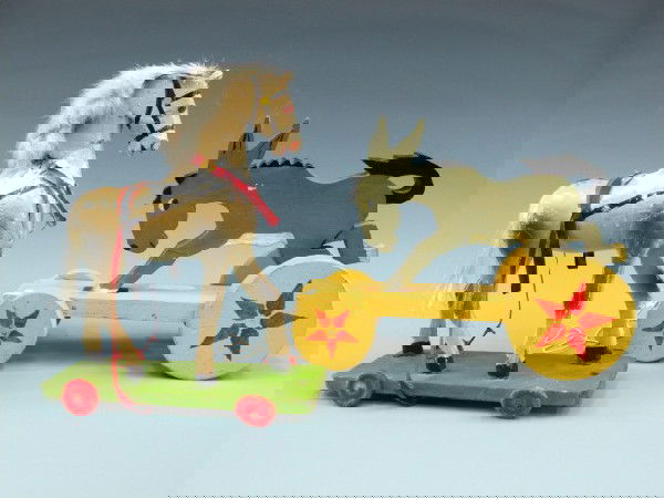 TWO WOOD CHILD'S PULL TOYS: A 10.5 x 3.5 x 9 inch balky mule of recent vintage and an older carved and gessoed 10.5 x 5 x 12 inch wood horse on platfrom.