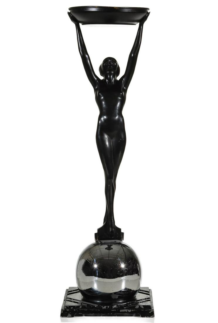 A FRANKART ART DECO ASH RECEIVER WITH FIGURAL NUDE: The design by Arthur von Frankenberg (1889 - 1950) for Frankart featuring a female nude with one foot in front of the other atop a chromed orb on geometric base holding a shallow receptacle high above