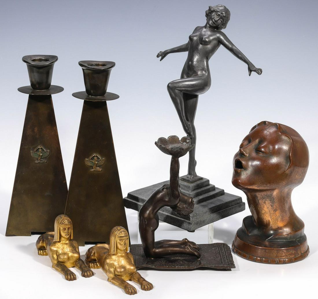 A COLLECTION OF ART DECO DECORATIVE ACCESSORIES: 1. A pair of metal candlesticks with triangular bases and Egyptian Revival imagery on each side, unsigned. 2. An Art Deco nude statuette, spelter figure bolted to a metal base, unsigned. 3. A spelter
