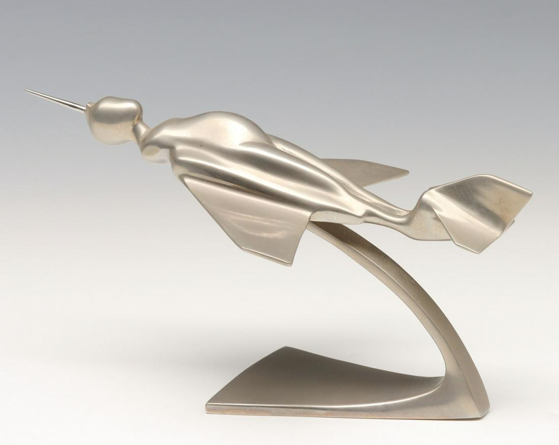 ERNEST TROVA (1927-2009) SCULPTURE: Ernest Tino Trova (1927-2009) 1970 The desk top model incorporating Ernest Trova's Falling Man motif with that of a jet aircraft is stamped with the maker's mark on the underside of the base. Measures