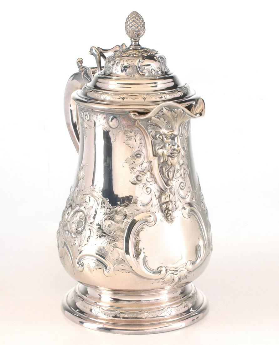 A HEAVILY CHASED SILVER PLATE PITCHER WITH HINGED COVER (1 of 16)