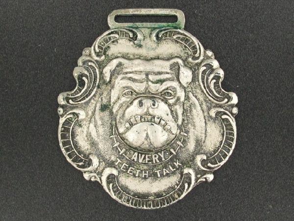 AVERY MFG CO TEETH TALK ADVERTISING WATCH FOB: Die struck, obverse with bulldog head and 'Avery Teeth Talk,' reverse with raised lettering, 'Avery Manufacturing Co., Farm Machinery, Engines, Threshers, and Steam Flows,' YF in wreath and 'Peoria, I