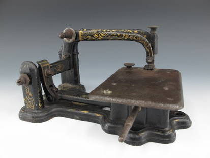 A WHEELER & WILSON SEWING MACHINE CIRCA 1853: Wheeler & Wilson plaque inset to base, unusual head, needle plate stamped with serial number 647570, 'The Wheeler & Wilson Mfg Co., Bridgeport, Conn.,' and patent dates, the last being Dec 19, 1853.