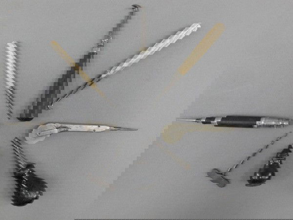 EIGHT ANTIQUE MEDICAL INSTRUMENTS: A 5.25 amalgam plugger with ivory handle; 3 inch screw extractor; 5 inch elevator - straight concave root; 2 inch ebony mercury holder; 5.5 inch stag foot root elevator; 5.5 inch amalgam filler with i