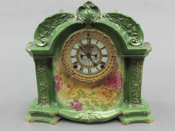 ANSONIA ROYAL BONN CHINA CASED MANTLE CLOCK: Royal Bonn marked reverse with raised relief 'La. Orb.,' T/S, double sunk enamel dial, beveled glass door. Hairline and crazing to case. Measures 12.5 x 14 x 5 inches.