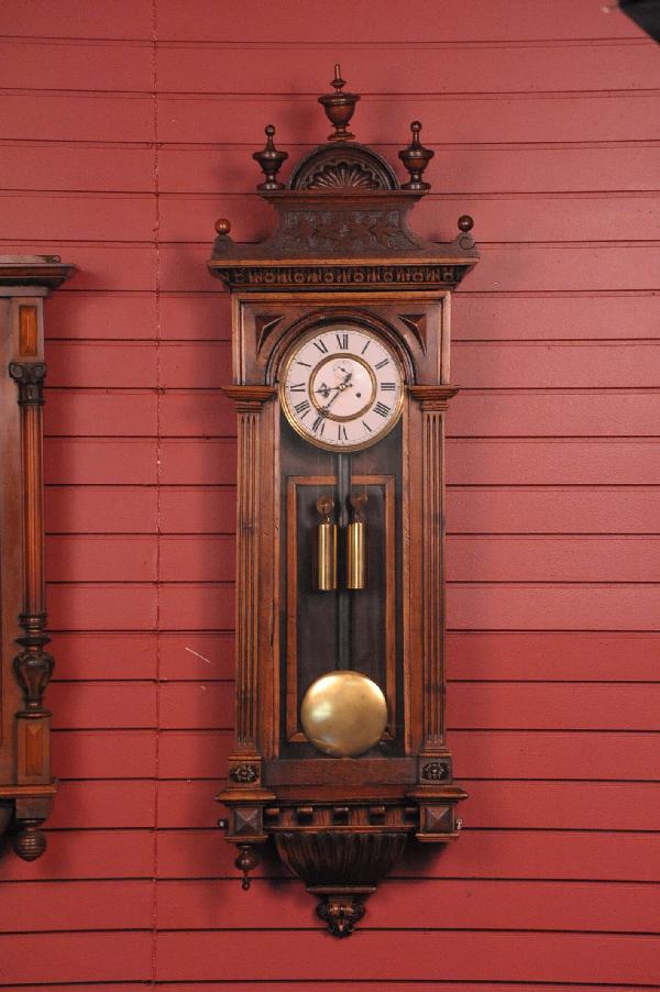 A TWO WEIGHT VIENNA REGULATOR WALL CLOCK: Two weight regulator with enamel inner dial and painted metal outer ring, fully refinished, measures 54 x 16.5 x 7 inches.