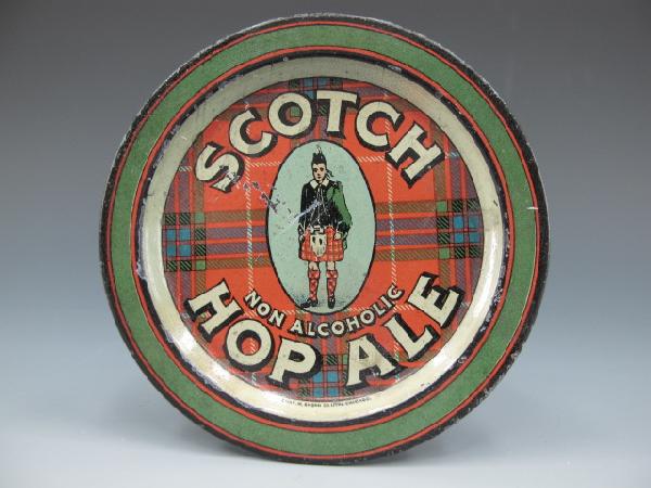 TIN TIP TRAY, SCOTCH HOP ALE, NON ALCOHOLIC: 3 1/2" man with kilt in center, plaid infield green ring outside.