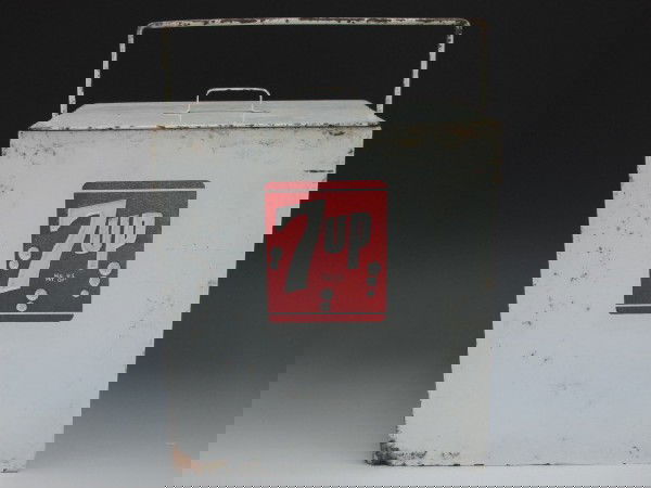 7-UP SODA POP BOTTLE COOLER: 11" x 10" x 7 1/2" holds six bottles, metal painted white, 7-UP on both sides is embossed, inside lined, lift off lid and bail.