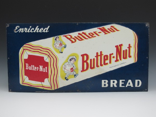 BUTTER-NUT BREAD TIN LITHO ADVERTISING SIGN: 13" X 27" Boy on bread wrapper with loaf in hand, sign reads Enriched Bread, Butter-Nut, Tyler baking company