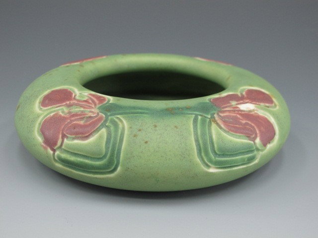 1907 CARVED MATTE ROOKWOOD POTTERY BOWL: Carved stylized florals in two colors, incised artist initials for Albert Pons, shape number 1111. Measures 1.5 x 5.25 inches.
