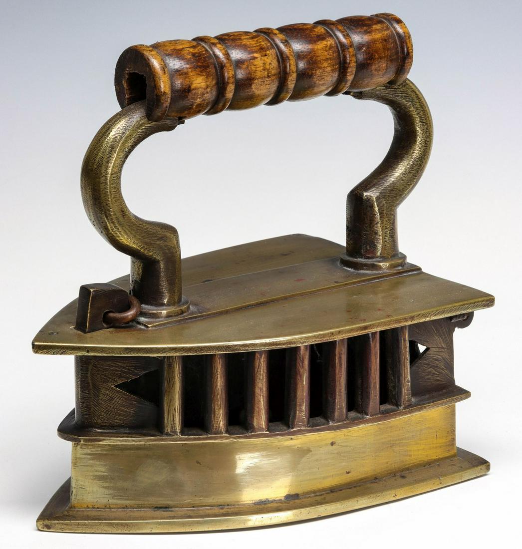 AN EARLY BRASS PRESSING IRON HEATED BY COAL (1 of 9)