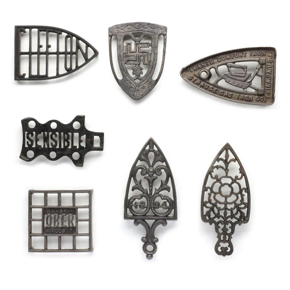 SEVEN ANTIQUE IRON TRIVETS WITH ADVERTISING (1 of 10)